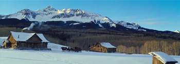 Snowy mountains and log cabins