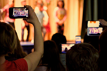 Essential Tips For Your First Stand Up Comedy Open Mic  people filming a comedy show on their phones