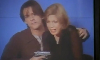 guy with a gun threatens a girl to tell the world she loves him