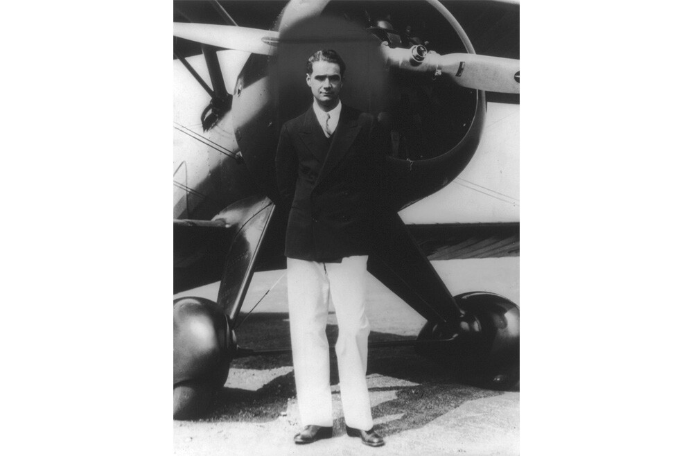 Howard Hughes standing in front of his new Boeing Army Pursuit Plane