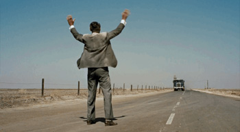 Carey Grant in front of a truck