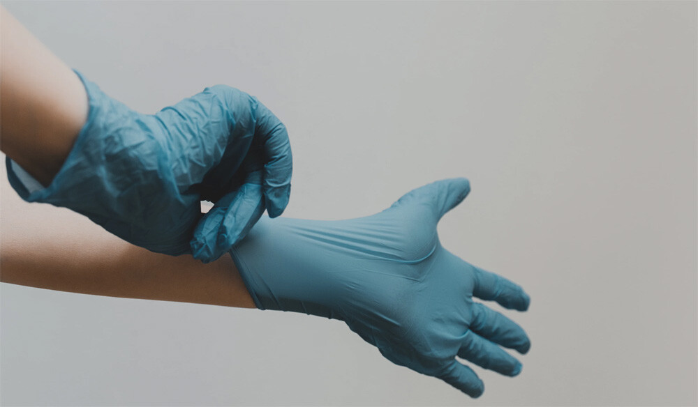 person in blue gloves