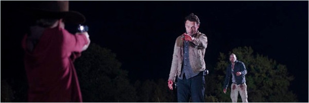 Carl aims a gun at Rick and Shane