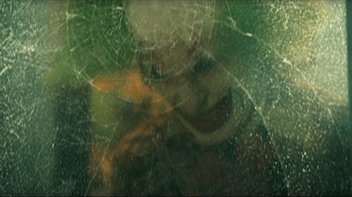 Joker headbutting the glass