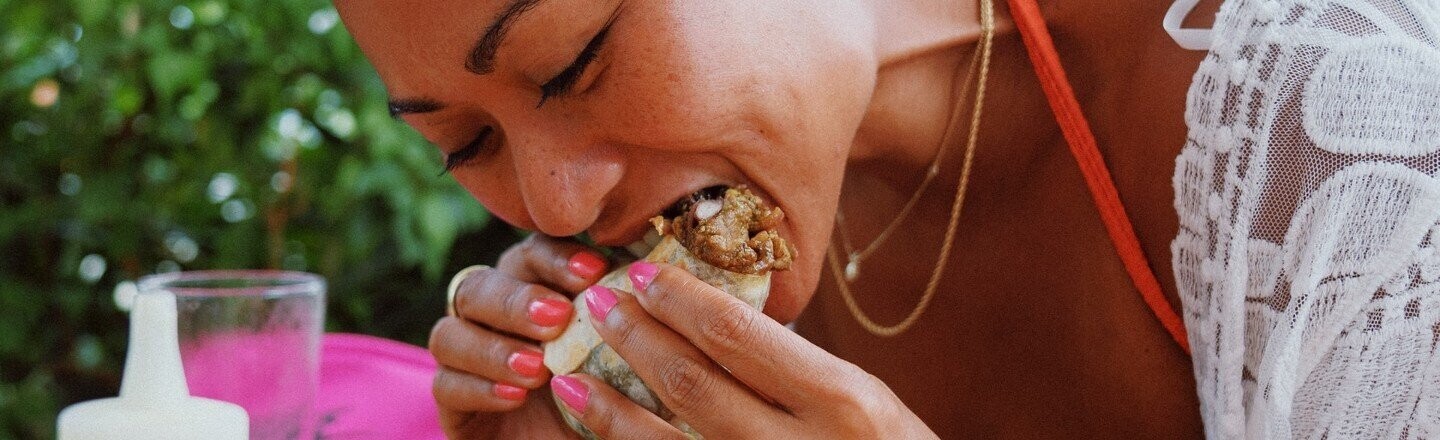 Woman eating burrito