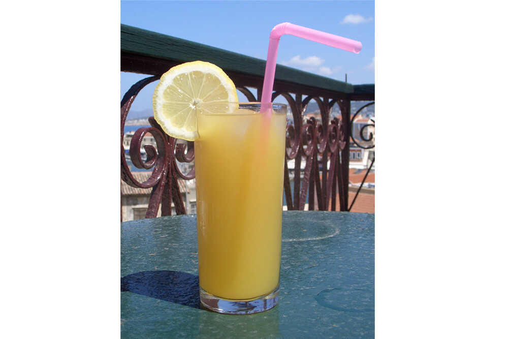 A pink articulated plastic straw in a drink