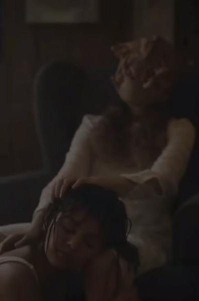 Selena Gomez gets her hair combed by a finger faced woman