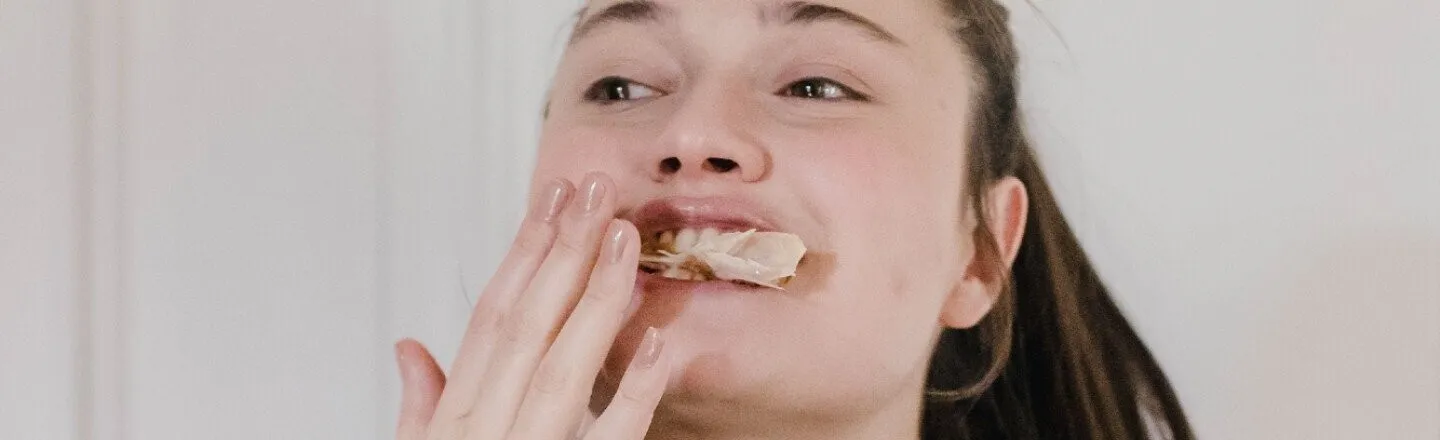 Woman eating chicken