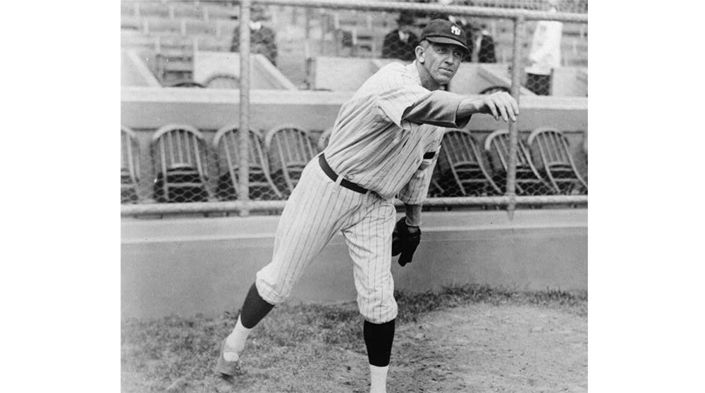 Raymond Benjamin Caldwell, Yankee pitcher, full-length portrait, facing right, with right arm extended outward after throwing baseball.