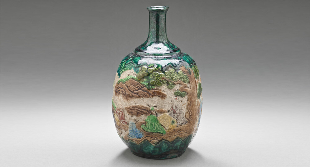 Gennai (Shido) ware sake bottle with design of scholars in garden, earthenware with clear glaze and colored enamels. Edo period, 18th century