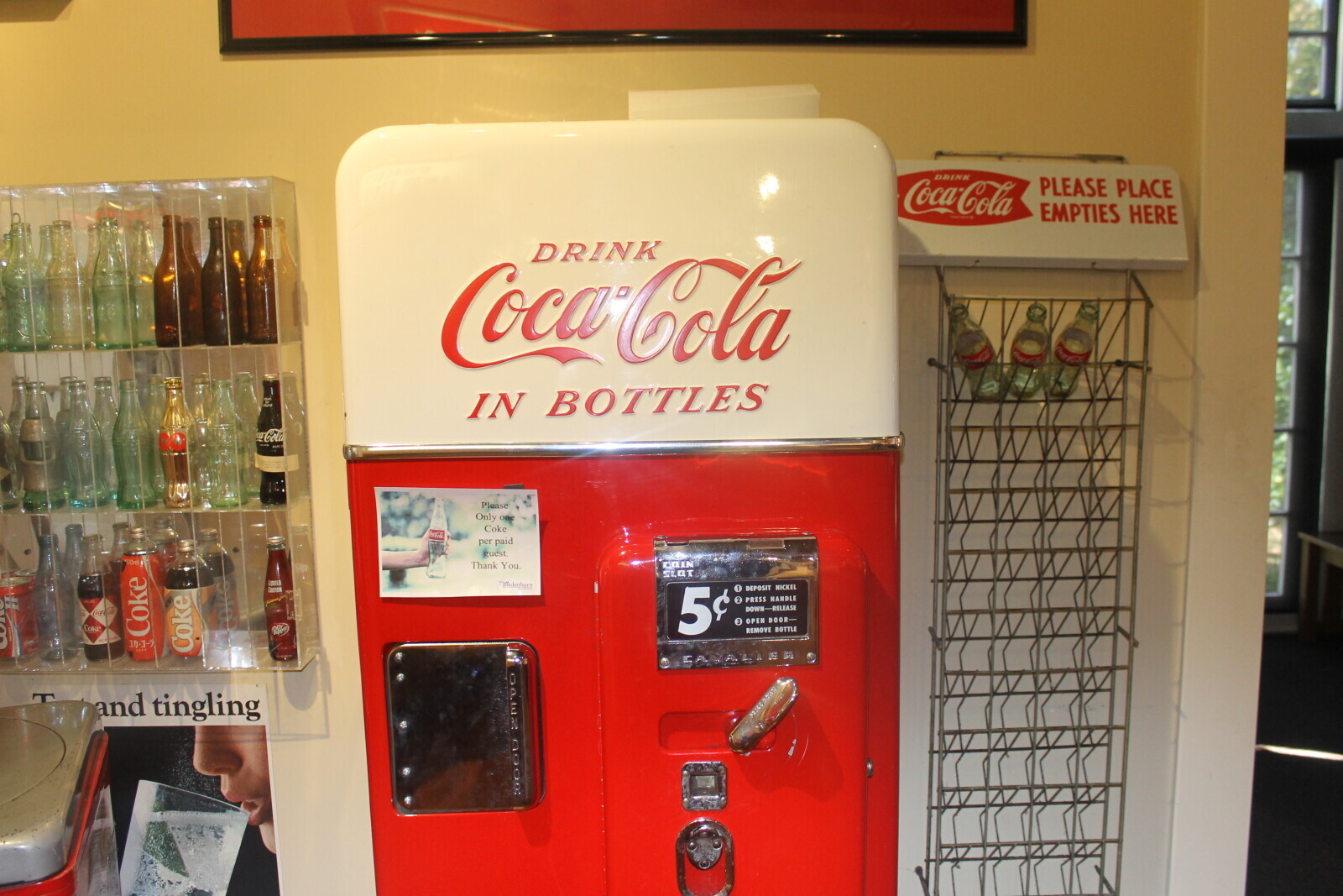 DRINK PLEASE PLACE Coca-Cola EMPTIES HERE DRINK Coca-Cola IN BOTTLES Coca-Cola Please Only one Coke CocaCola per paid guest. 00ml Thank You. COIN SLOT LIMITED Bledenharn DEPOSIT NICKEL EDITION M 5 2 PRESS HANDLE DOWN-RELEASE Coca-Cola 3 OPEN DOOR- Coke RDCARD REMOVE BOTTLE Coke Coke 04.02 490g T and tingling