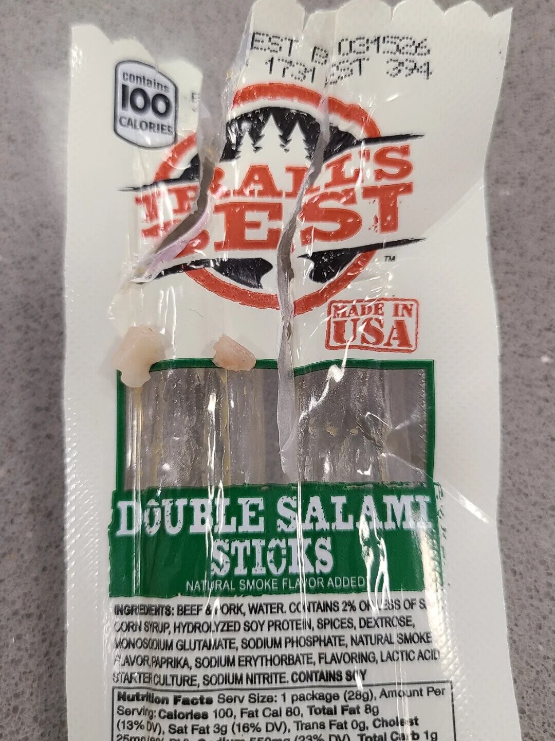 EST B 031526 contains 1731 EST 394 100 CALORIES ALL'S JR EST TM MADE IN USA DOUBLE SALAMI STICKS NATURAL SMOKE FLAVOR ADDED INGREDIENTS: BEEF &PORK, WATER. CONTAINS 2% OR LESS OF S CORN SYRUP, HYDROLYZED SOY PROTEIN, SPICES, DEXTROSE, MONOSODIUM GLUTAMATE, SODIUM PHOSPHATE, NATURAL SMOKE FLAVOR,PAPRIKA, SODIUM ERYTHORBATE, FLAVORING, LACTIC ACID STARTERCULTURE, SODIUM NITRITE. CONTAINS SOY Nutrition Facts Serv Size: 1 package (28g), Amount Per Serving: Calories 100, Fat Cal 80, Total Fat 8g (13%DV), 25mg/99/ Sat - Fat 3g Heams (16% DV), Trans Fat 0g, Cholest 550mg (23% DVY Total Ca b 1g