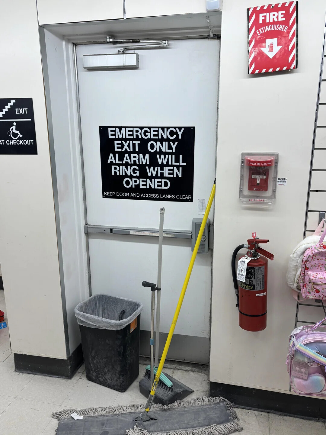 FIRE EXTINGUISHER EXIT EMERGENCY AT CHECKOUT EXIT ONLY ALARM WILL M CASE OF E COVER RING WHEN 2004 POLL DOWN Ehrtlen OPENED - grimatee KEEP DOOR AND ACCESS LANES CLEAR LIF I MERE CIVIL sentry كتنا