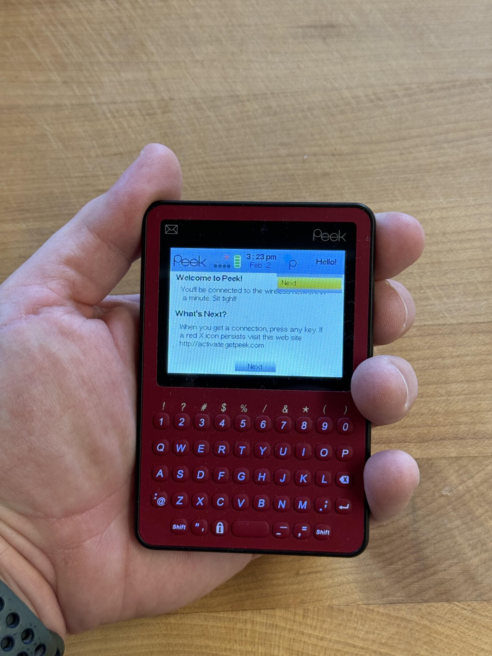 Peek 3:23 pm Peek Hello! Feb 2 p Welcome to Peek! Next You'll be connected to the a minute Sit tight! What's Next? When you get a connection, press any key If a red X icon persists visit this web site http://activate getpeek.com Next ? # $ % * / & 1 2 3 4 5 6 8 7 9 O Q W E R T Y U I o P A S D F G H J K L X Z @ X C V B N M i لم Shift A 1. = Shift