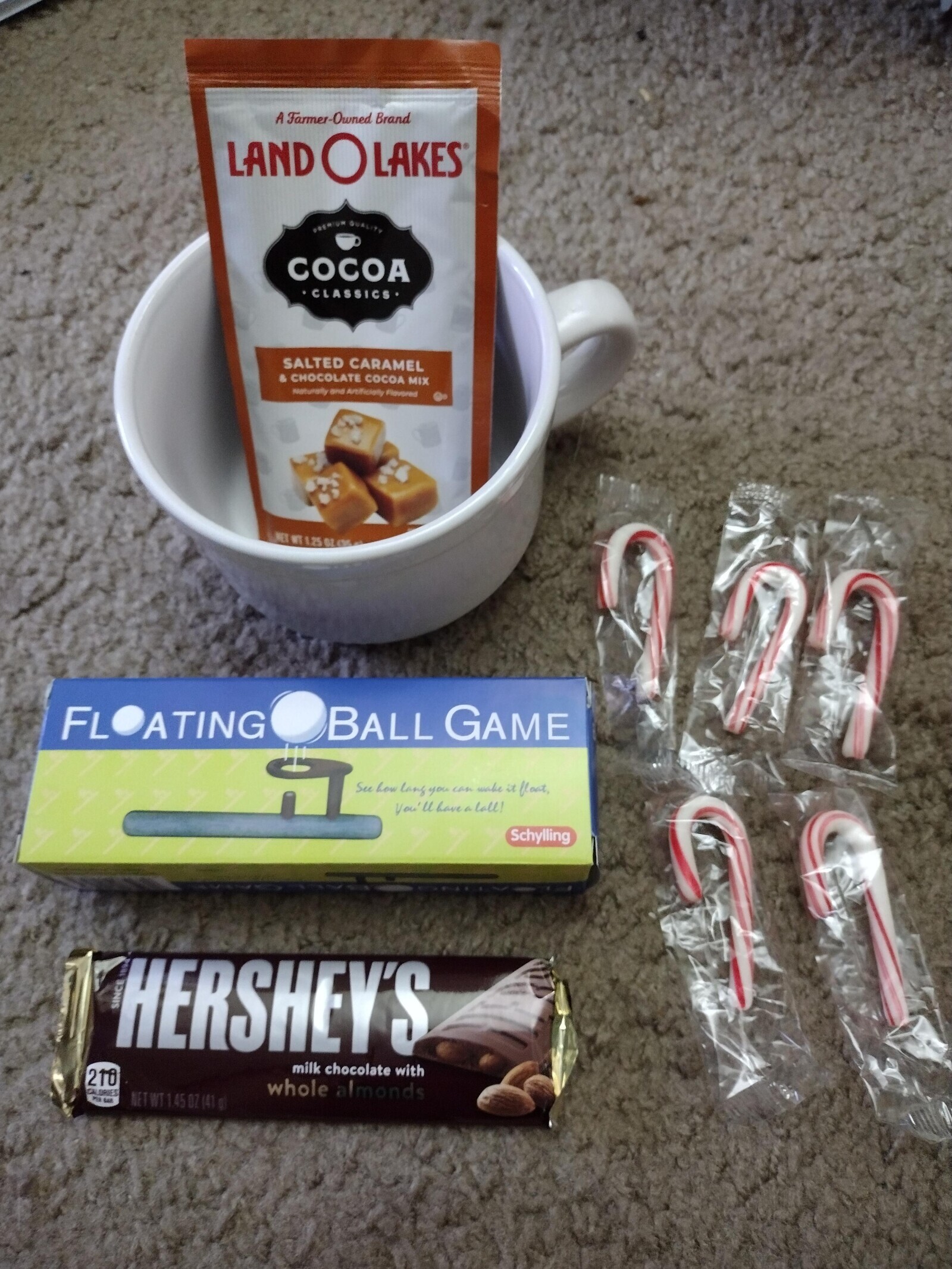 A Farmer-Owned Brand LAND O LAKES PREMIUM QUALITY COCOA CLASSICS SALTED CARAMEL & CHOCOLATE COCOA MIX Naturally and Artificially Flavored NET WT 125 OL 0% FL OATING BALL GAME See how lang you can wake it float, you u have a lall! Schylling SINCE HERSHEY'S a milk chocolate with 210 CALORIES whole almonds 35g Eat NET WT 1.45 OZ (41 a
