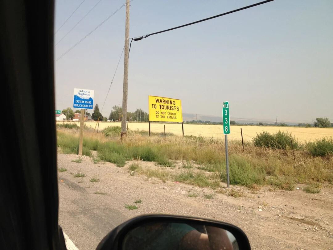 Adopt d Highway WARNING MILE EASTERN IDAHO TO TOURISTS PUBLIC HEALTH DIS DO NOT LAUGH AT THE NATIVES RTH 3 3 8