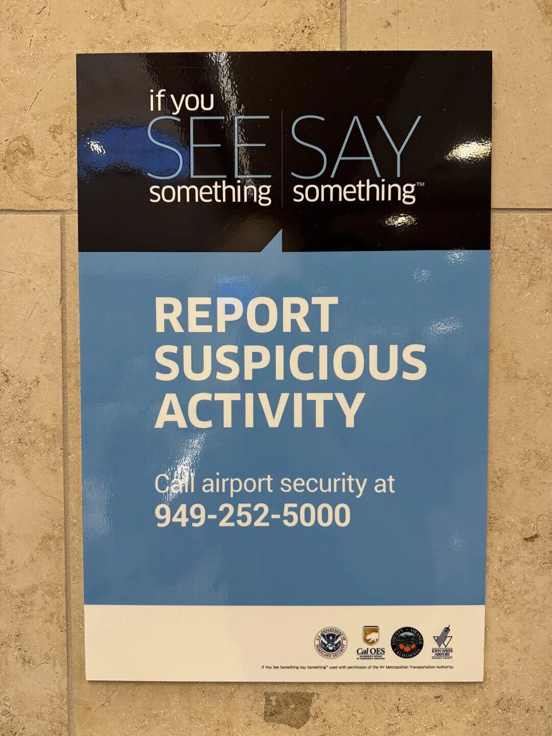 if you SEE SAY something something REPORT SUSPICIOUS ACTIVITY Call airport security at 949-252-5000 E INFORMATION NONELAND INTERNATIONAL Cal OES COUNTY CALIFORNIA ORANGE JOHN WAYNE AIRE .. - I If You See Something Say Something used with permission of the NY Metropolitan Transportation Authority