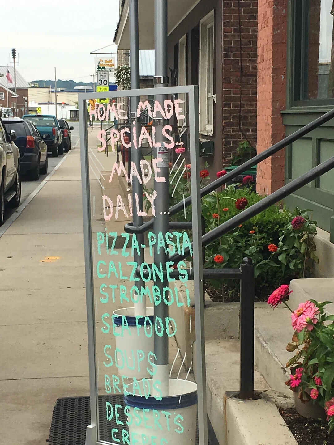 Bell Alpraga VILLAGE SPEED LIMIT 30 TRUCK HOME-MADE SECIALS For MADE IDAILY...? PIZZA-PASTA CALZONES STROMBOLI SEA FOOD SOUPS BREADS DESSERTS CREDEC