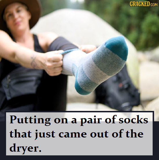CRACKED.COM Putting on pair of socks a that just came out of the dryer.
